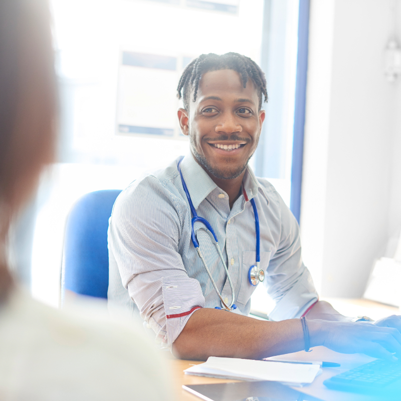 Smiling medical professional speaking to a patient