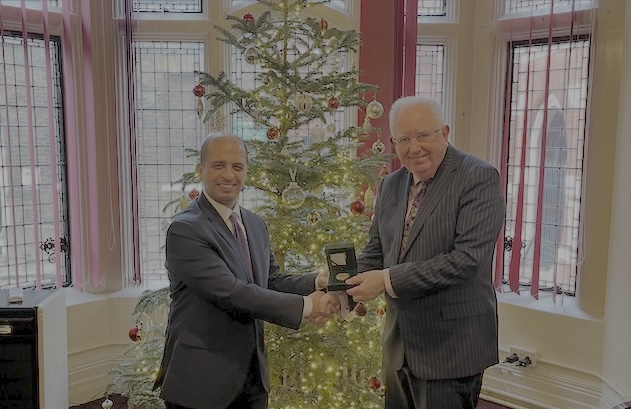 Prof Sir Mark Caulfield is presented with Kuwait medal